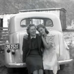 Evelyn with a friend (name unknown, but we believe it was her sister-in-law via her first husband) Circa 1942 Sitting on the bumper of Evelyn's new car