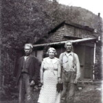 Charlie, Signe and Gus Ekburg, standing in front of the "Red" house. (notice camera in Gus's hand.)