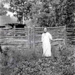 Beda in her vegetable garden. You can see the the same background buildings in the color images.